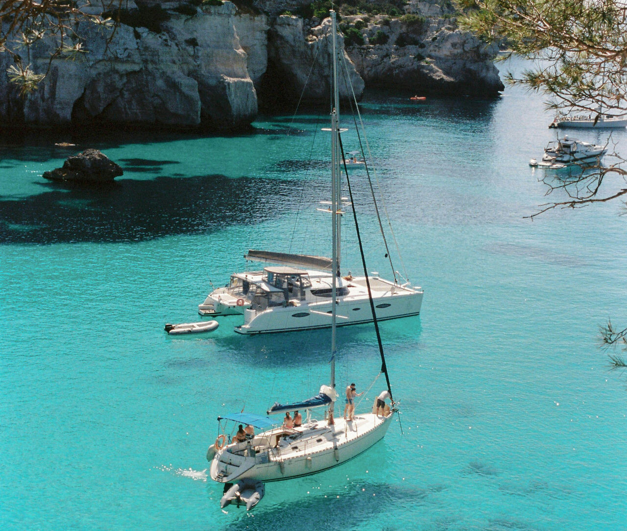Sailing boats anchored in turquoise Adriatic sea close to Trogir